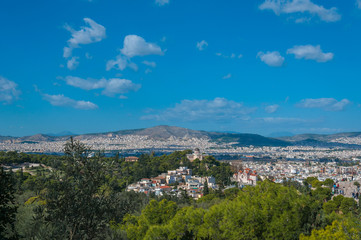 Fototapeta na wymiar Beautiful panorama of the city of Athens seen from the Acropolis, Greece. Concept: classical culture, famous monuments, ancient history, cultural travel, visiting unesco world heritage