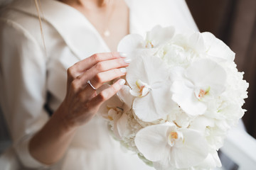 Obraz na płótnie Canvas Bride holding big and beautiful wedding bouquet with flowers