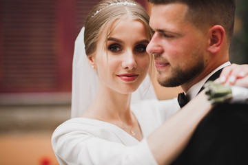 Romantic wedding moment, couple of newlyweds smiling portrait, bride and groom hugging