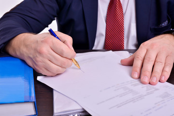 Men's hands sign documents of contracts, business, success, prosperity, power