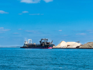 view of bay area with cargo ship and factory in Fukuoka prefecture, JAPAN.