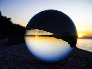 Glass ball on a background of the sea