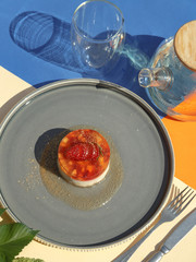 Strawberry creamy dessert in a serving with green tea on a colorful background