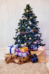 Christmas tree with Garland decoration and gifts for the new year