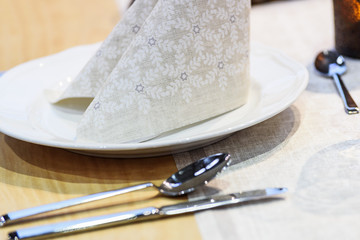 Simple and elegant wedding or festive table setting with napkin in close-up