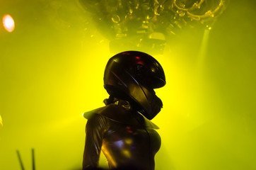 Go Go dancer in motorcycle helmet on the stage of night club