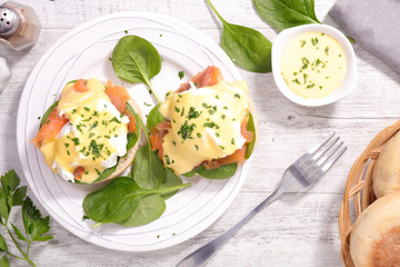 muffin with poached egg, sauce and salmon