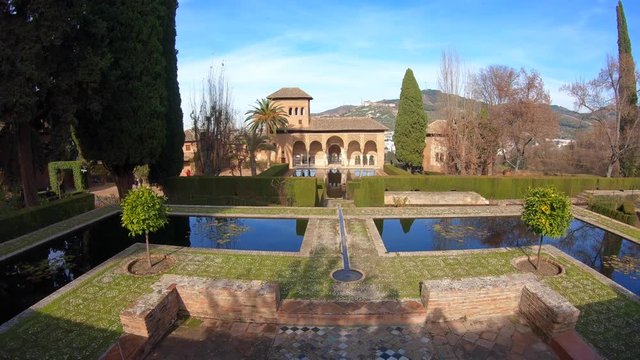Panning view the gardens of the Partal in Alhambra Place. Granada, Andalusia, Spain. Pamoramic shot, 4K.