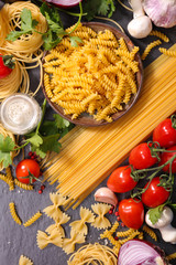 assorted of raw pasta with spice and ingredient, top view