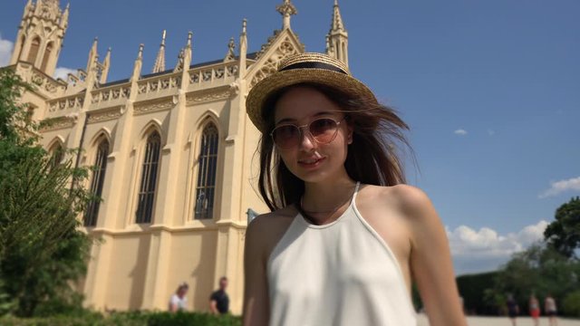 Lady against the grand gothic castle. Lednice, Czechia