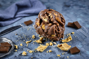Ball shaped traditional German sweet food called 'Schneeballen', meaning 'Snowball', made from shortcrust pastry glazed with chocolate, a speciality from tourist city Rothenburg