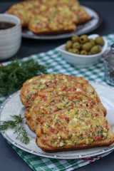Homemade sandwiches with cheese and sausage before baking on parchment on a baking sheet, the cooking process, Vertical orientation