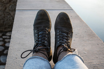 Islolated feets with black boots  