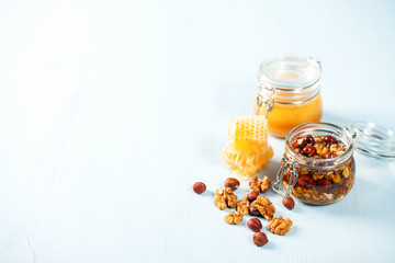 A honey jar with a nuts