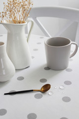 light table with ceramic cup and spoon, close-up