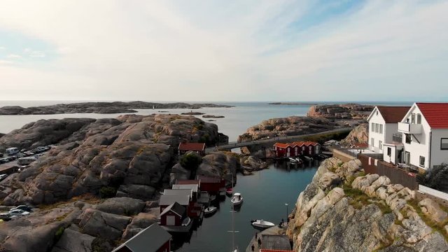 Smooth aerial drone flight towards the ocean and over a canal in Smogen, Bohuslan in Sweden