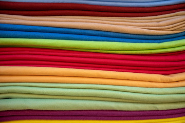 Pieces of fabric and textiles in a factory shop or store or bazar. Multi different colors on the market.