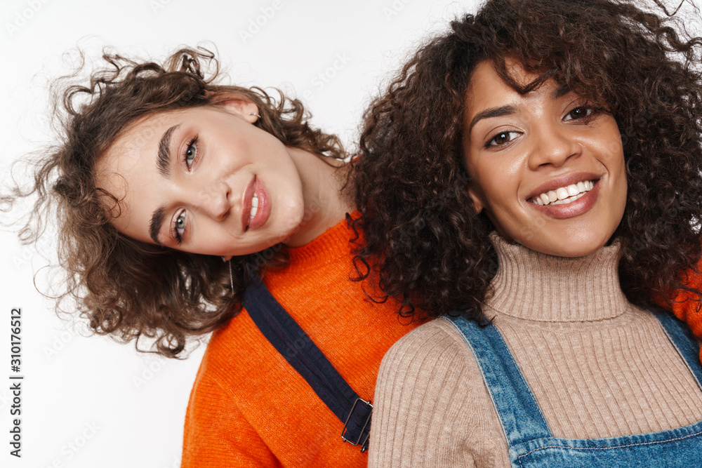 Wall mural Optimistic two multiracial girls friends