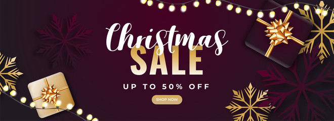 Fototapeta na wymiar Christmas Sale Header or Banner Design with 50% Discount Offer, Top View Gift Boxes, Snowflakes and Lighting Garland Decorated on Burgundy Background.