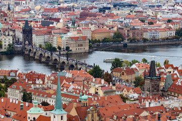 Fototapeta na wymiar The Red Roofs of Prague With the Charles Bridge