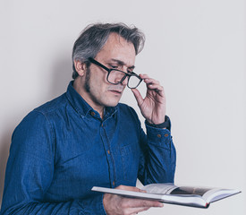 man with presbyopia reading a book