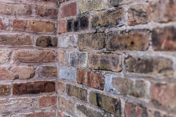 Corner of a red brick wall with lots of texture