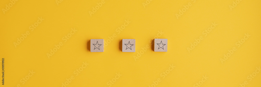 Wall mural three wooden blocks with star shape on them placed in a row
