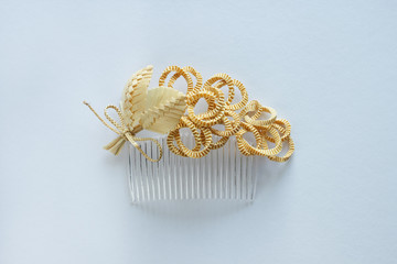 Ornamental hair comb with straw flowers on a white background