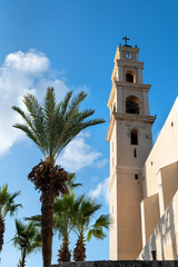 View on monastery Saint Peter with bell tower in Jaffa, Israel-Yafo. Clock Tower with Cross