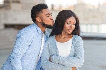 Friend zone concept with a man trying to kiss a woman and she rejecting him - obrazy, fototapety, plakaty