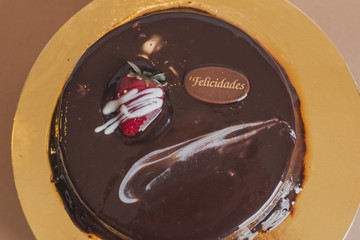 Sweet chocolate cake on gold table