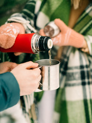 Happy couple drinking coffee in winter