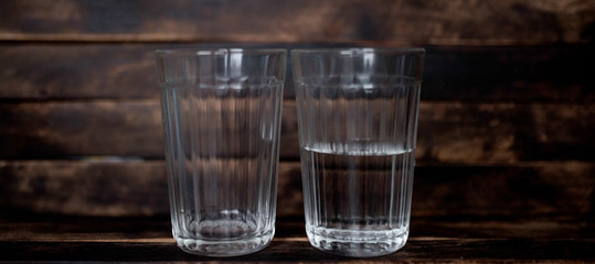 faceted glass of water and empty half half full