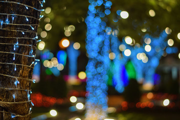 Light decorative outdoor hanging string lights hanging on tree in the garden at night time festivals season