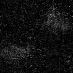Fototapeta na wymiar A large number of white scratches on the black .Texture or background like a needle