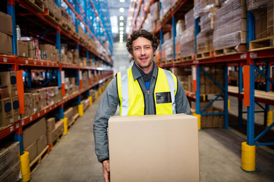 Warehouse worker carrying a box 