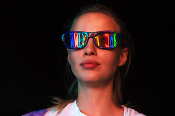 Image of young woman in 3D glasses watching movie in dark cinema room