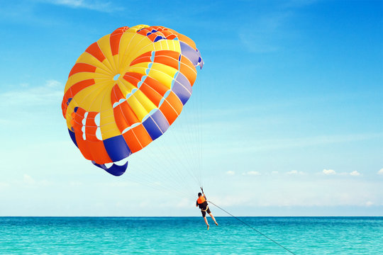 Parasailing on Tropical Beach. Freedom in fly on parachute.