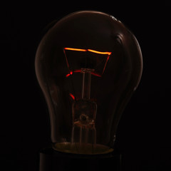 light bulb on a black background with a burning spiral