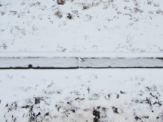 A border in the snow. Snowy lawn.