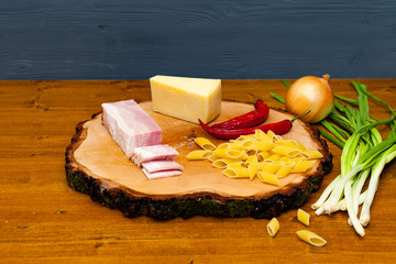 Ingredients for Carbonara paste. Italian cuisine. bacon, Parmesan cheese, Penne, onions and spices