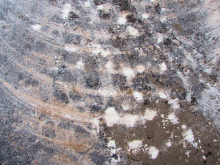 Asphalt road in the snow and sand