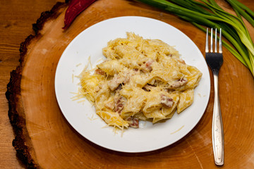 Pasta Carbonara dish on wooden background