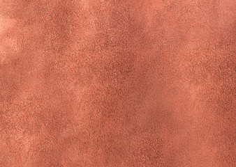 The wrong side of faux leather with a textured rough surface of brown color