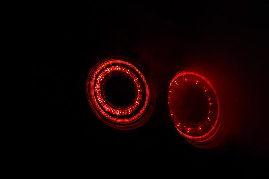 Alight rear lights Nissan GT-R in the dark garage with smoke