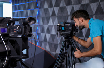 Professional video camera operator working in studio
