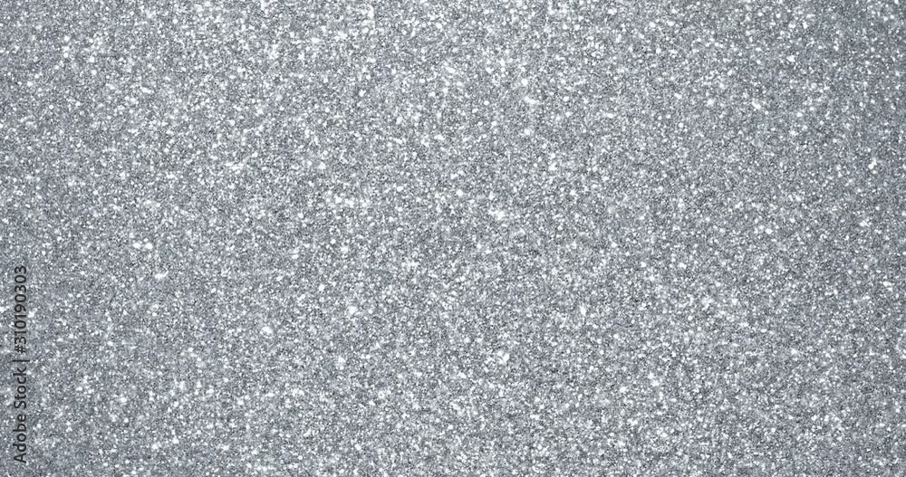 Poster silver glitter background with sparkling texture. silver shimmering light, stars sequins sparks and 