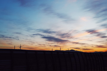 At sunset, the reddish sky and still blue winter sky.