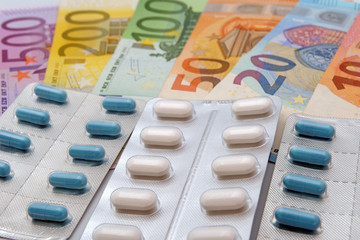 drug and medicine tablets with euro banknotes money