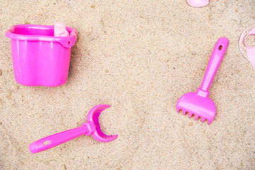 Fototapeta na wymiar Toy scoop, bucket and rakes in the sand